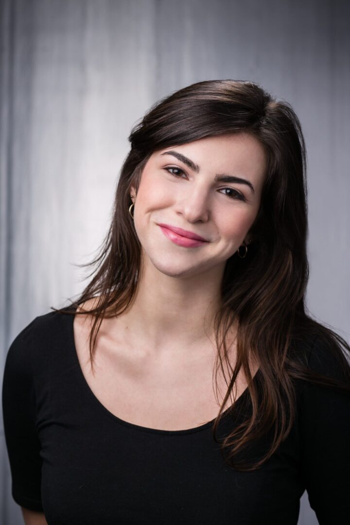 A woman with long hair wearing black shirt