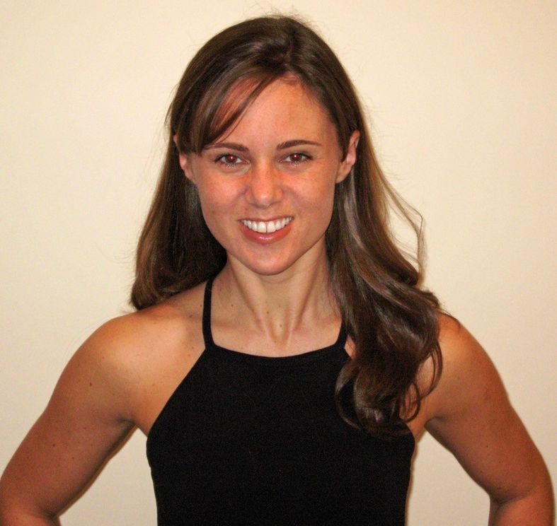 A woman in black shirt smiling for the camera.